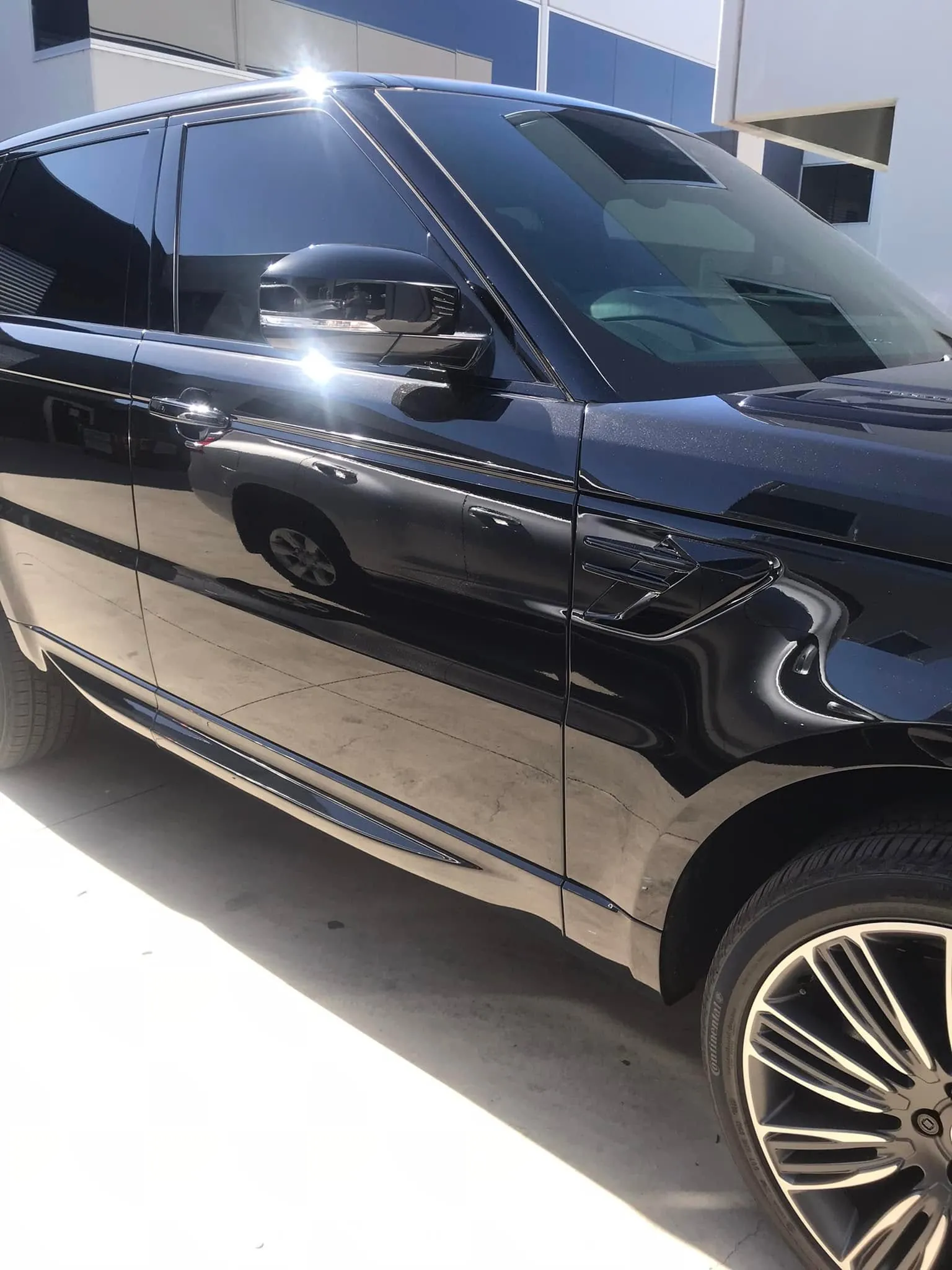 Sleek black car with fresh window tint by KEN Express